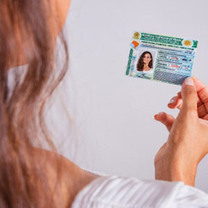 Woman holding a green ID card